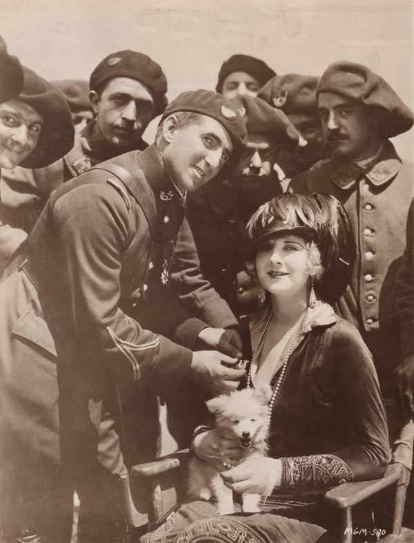 Lieutenant Auguste Monchio of the 'Blue Devils' decorates Alice Terry on the set of Mare Nostrum